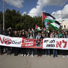 Demonstrators holding large banner, flags 