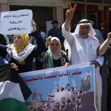People hold up banners during a demonstration