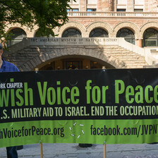 Protestors hold up a banner urging the US to end military aid to Israel