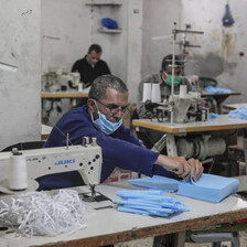 Men sewing protective face masks