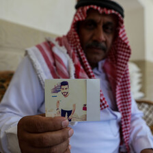 Man holds photograph 