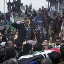 Man salutes corpse carried by mourners 