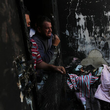 Man weeps in badly damaged house 