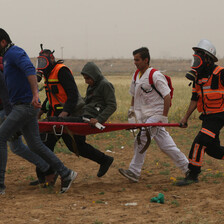 Medics rush an injured demonstrator to safety