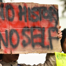 A protester holds a sign