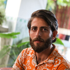 Man sits in front of plant 