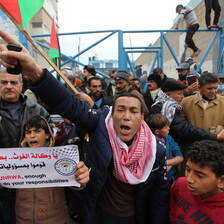 People carry flags and banners during a protest