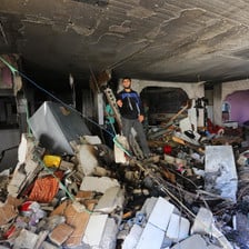 A man stands in a severely damaged building 