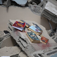 Books amid the rubble of a destroyed building