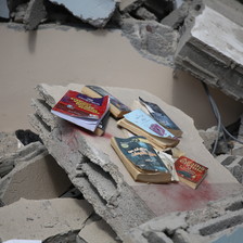 Books amid the rubble of a destroyed building 
