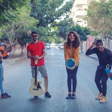 A group of people hold musical instruments