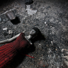 A broken mannequin lies on a floor 