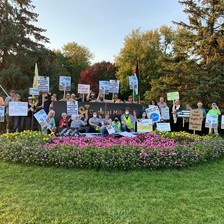 Protesters with signs pose for group photo at General Mills campus 