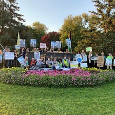 Protesters with signs pose for group photo at General Mills campus