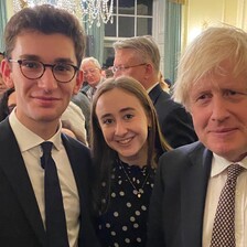 Three people posing at a reception