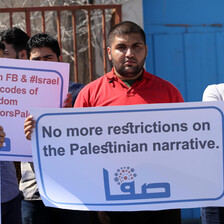 People hold signs against social media censorship