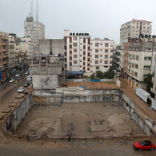 A space between housing blocs marks the place where al-Jawhara Tower used to stand