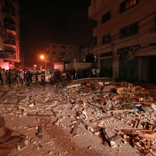 People stand around an area that has been severely damaged 