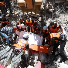 First responders search amid the rubble of bombed buildings