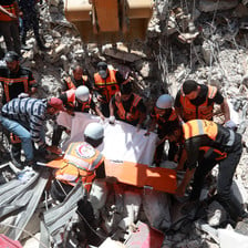 First responders search amid the rubble of bombed buildings 