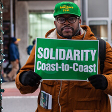 A man holds a sign