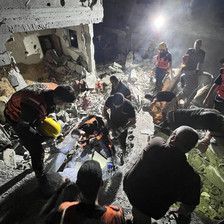 Palestinian rescue crew search beneath the rubble for survivors of an Israeli airstrike in Rafah