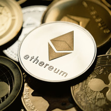 An ethereum coin lies atop several other digital currencies