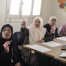 Palestinian women in Gaza in a classroom participating in reading lessons