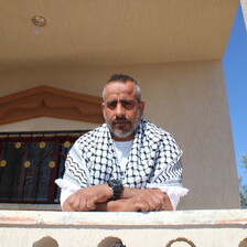 Man wearing a chequered black and white scarf 