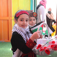 Palestinian child holds a bouquet of roses