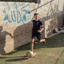 Ahmad Dawabsheh runs with a football at his feet