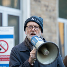 Man wearing hat holds megaphone