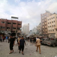 People walk in the city of Rafah after it was attacked by Israel 