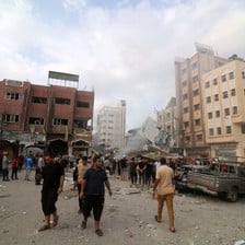 People walk in the city of Rafah after it was attacked by Israel 