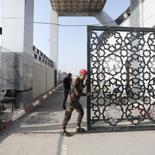A soldier opens the gate of the Rafah crossing in southern Gaza.