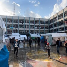 Makeshift tents in the courtyard of an UNRWA school in Rafah, the ground wet from a recent rain