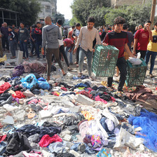 Young men beside various items strewn on the ground following an Israeli airstrike in Gaza. 