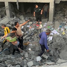 A child is carried by a young man amid the remains of a building that has been attacked in Gaza 