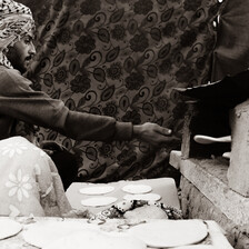 Man reaches for freshly baked bread