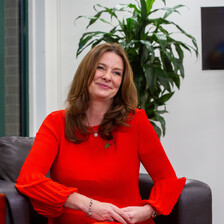 A woman in chair, smiling