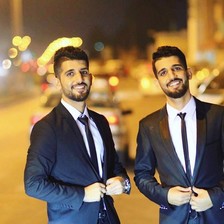 Twin brothers Khalid and Salah Jadallah wearing suits 