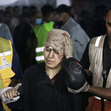 A woman in distress is guided by two emergency workers