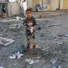 A boy stands amid the rubble in Gaza 