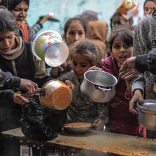 A large number of children wait for a small amount of food in the southern Rafah city of Gaza 