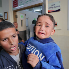 One child holds another distressed child