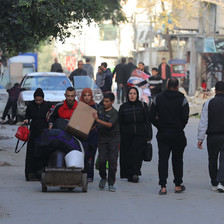 A family carry their belongings after they have been ordered to leave their home in Gaza 