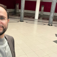 A man takes a selfie in an empty hall
