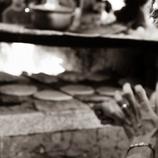 Bread is prepared in a makeshift oven.