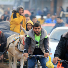 People on donkeys, walking, in cars