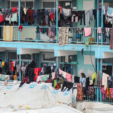 Tents and washing lines compete for space in a school